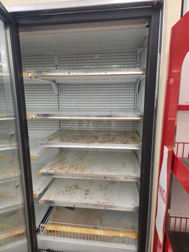 Hussmann Gel-5 frozen food door with shelving, no compressor. Visible wear on shelves. Sold by door, buyer removes.