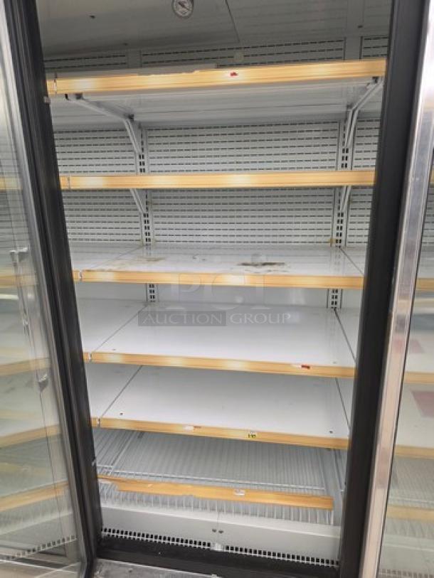 Hussmann Gel-5 frozen food door with shelving, no compressor. Shelves intact, minor wear. Sold individually; tools required for removal.
