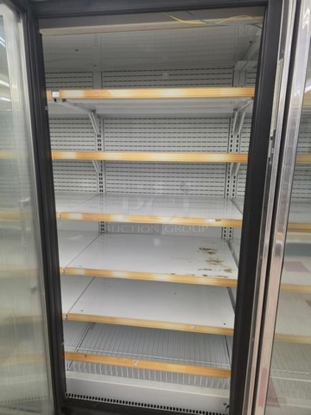 Hussmann Gel-5 frozen food door with shelving, no compressor. Visible wear on shelves. Buyer responsible for removal.