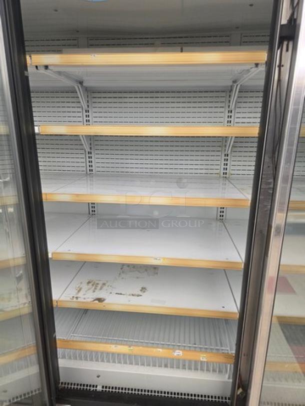 Hussmann Gel-5 frozen food door with shelving, no compressor, sold individually. Condition shows wear; buyer removes.