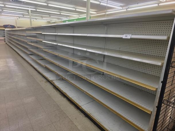 Double-sided gondola shelving, 65-foot, featuring multiple adjustable shelves. Good condition, pegboard backing.