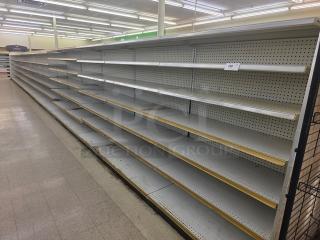 Double-sided gondola shelving, 65-foot, featuring multiple adjustable shelves. Good condition, pegboard backing.
