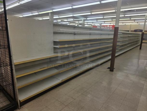 Double sided gondola shelving, 65 feet, with multiple tiers, used condition, buyers responsible for removal.