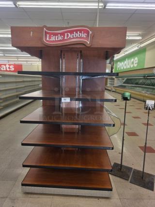 Little Debbie retail display shelf with five wooden tiers, branded top sign, sturdy construction, suitable for merchandising.
