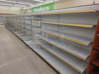 Single sided gondola shelving, 63' long, gray, pegboard back, adjustable metal shelves, good condition. Buyer to remove.