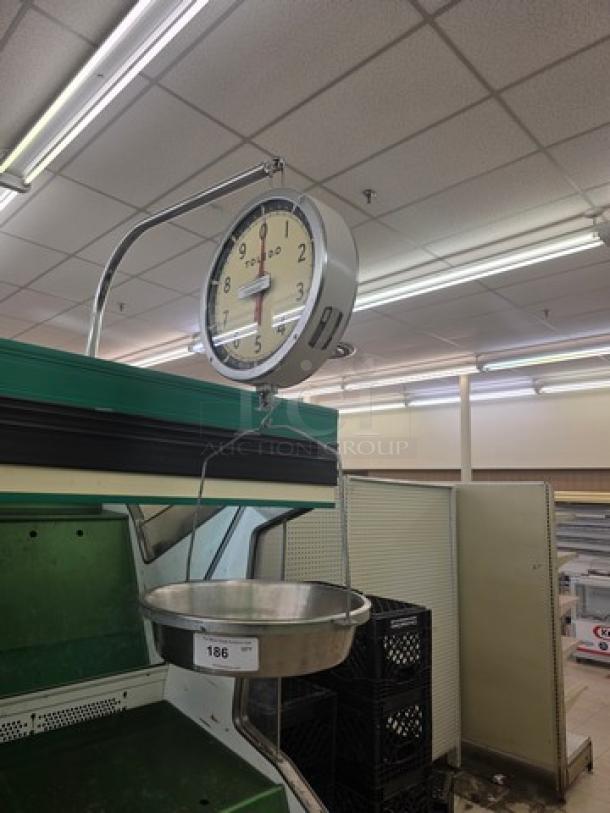 Toledo Model 2110 commercial hanging scale with large round dial, metal frame, and attached weighing pan.