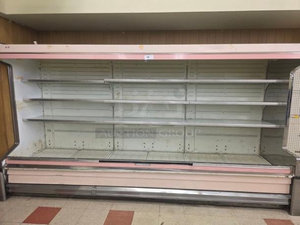 Hussmann DM12ZAU 12' dairy case with ends, featuring adjustable shelves. Visible wear, suitable for large-capacity display.