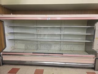 Hussmann DM12ZAU 12' dairy case with ends, featuring adjustable shelves. Visible wear, suitable for large-capacity display.