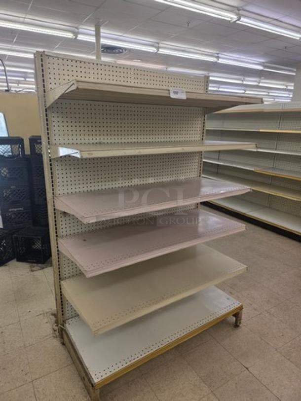 Gondola shelving unit with adjustable metal shelves, pegboard back, and beige finish. Ideal for retail display. Buyer removes.