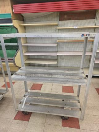 Aluminum Mobile Shelf Cart with three slatted shelves, sturdy frame, wheeled base for easy transport, slight wear, measures approximately 48x18x60 inches.