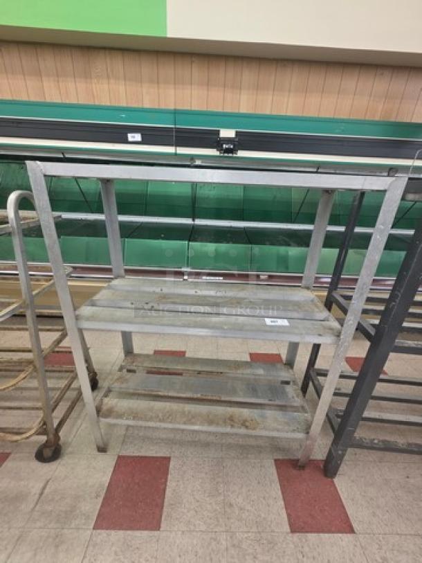 Aluminum shelf cart with three tiers, used condition, shows signs of wear, ideal for storage or transport.