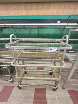 Aluminum mobile shelf cart with three glass shelves, sturdy frame, visible wear, and numbered tag 208.