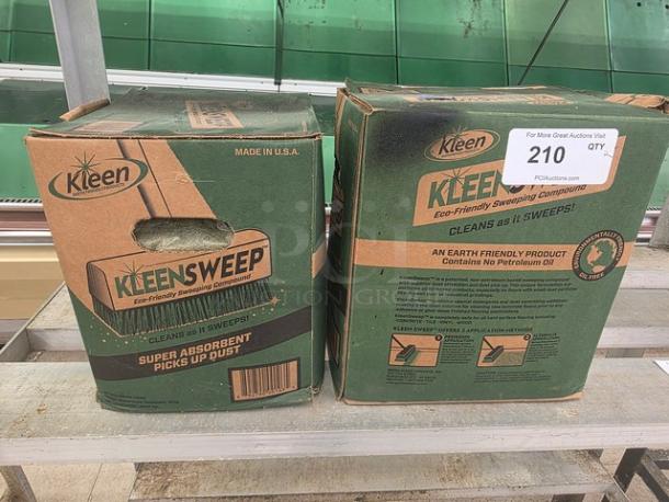 Lot of 2 boxes of Kleen Sweep Eco-Friendly Sweeping Compound. Super absorbent, made in USA. Tag indicates quantity and auction info.