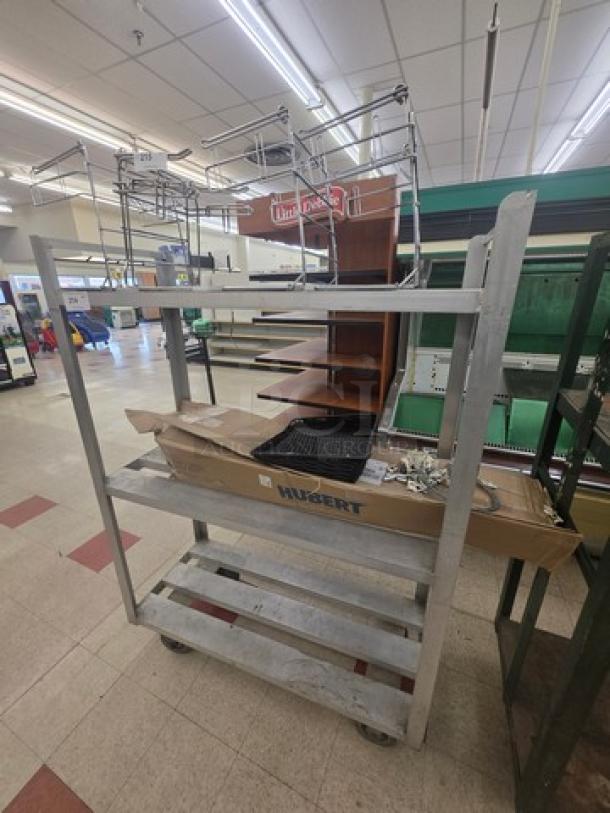 Aluminum mobile shelf cart with three tiers, sturdy frame, on wheels for easy transport. Includes a Hubert-branded box. Good condition.