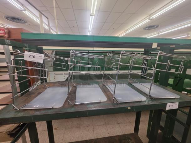 Lot of 4 T-Shirt Bag Racks, metal frames with base panels, used condition, suitable for retail display.
