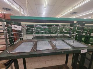 Lot of 4 T-Shirt Bag Racks, metal frames with base panels, used condition, suitable for retail display.