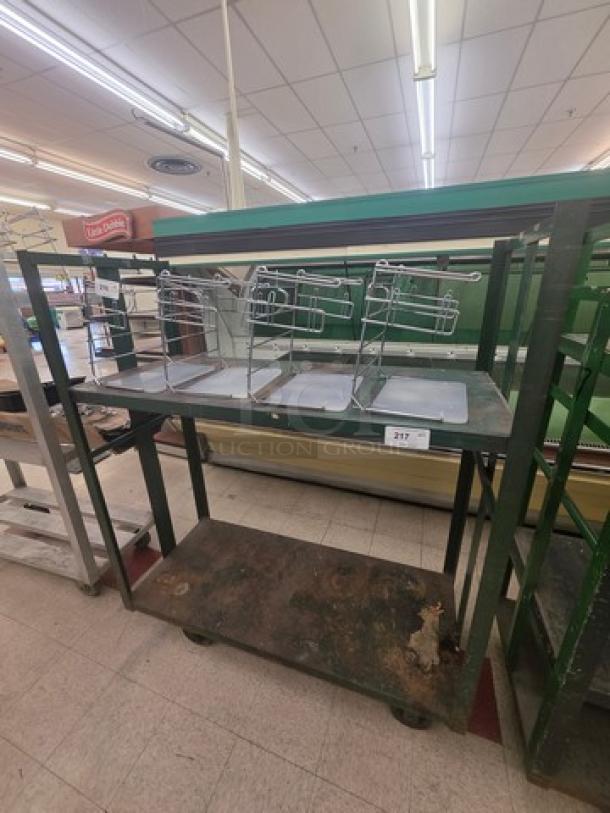 Industrial shelf cart with dual metal tiers and integrated wire racks. Shows signs of rust and wear. Label indicates item number 217.