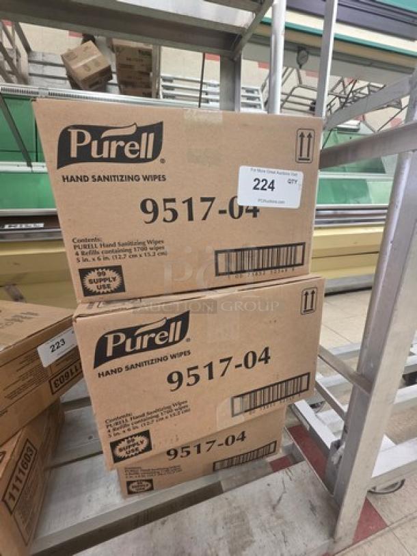 Three boxes of Purell Hand Sanitizing Wipes, model 9517-04, unopened in original packaging, with labels and barcodes visible.