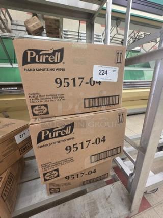 Three boxes of Purell Hand Sanitizing Wipes, model 9517-04, unopened in original packaging, with labels and barcodes visible.