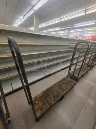 Industrial stock cart with metal frame and wooden platform, used condition. Ideal for warehouse or retail use.