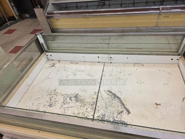 Hussmann ISMG-5R single-deck refrigerator island merchandiser with visible wear on interior surface.