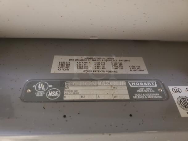 Hobart commercial hand wrap station, model ML, 120V, NSF certified. Features patent details and UL listed label. Made in USA.