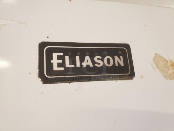 Eliason walk-in door with visible brand label; includes hardware. Appears in solid condition, suitable for commercial use.