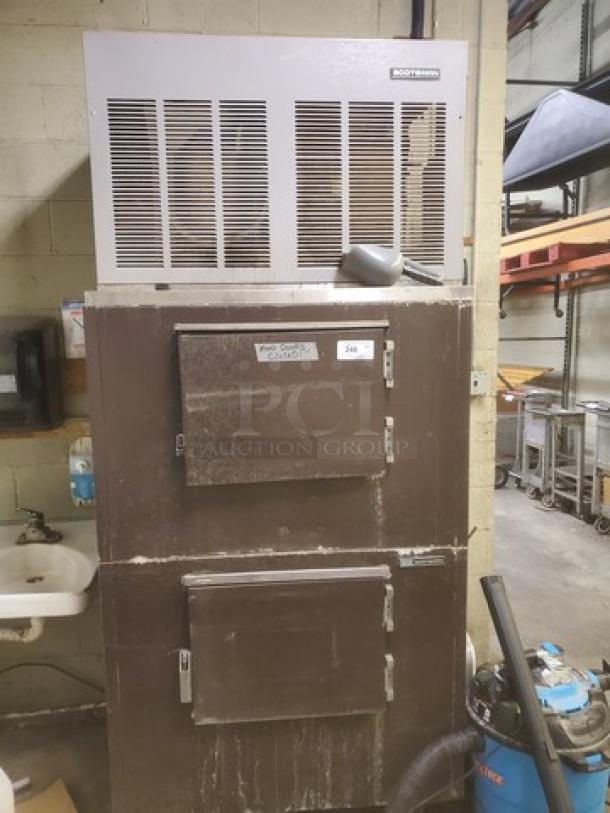 Scotsman FME2400AE-3A flake ice machine with bin, used condition. Features a ventilation grill and storage compartments.