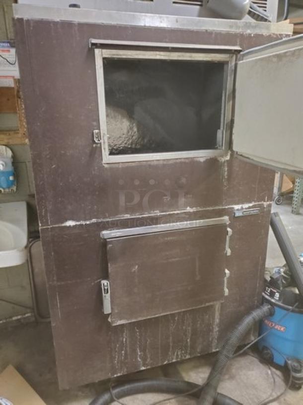 Scotsman Flake Ice Machine with Bin, Model FME2400AE-3A, showing wear. Large metal structure, visible bin and access panel.