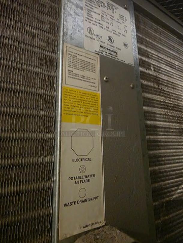 Scotsman Flake Ice Machine, Model FME2400AE-3A, close-up of labels showing electrical specs, water connection, and waste drain info.