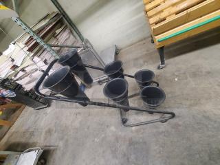 Mobile flower display stand with six black cones on a metal frame. In good condition, ideal for showcasing floral arrangements.