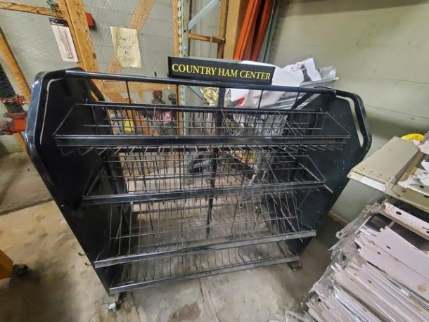 Metal wire display rack with multiple shelves, labeled "Country Ham Center," in used condition, on caster wheels.