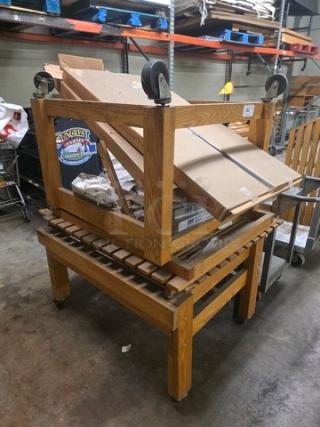Lot of 2 wooden display stands on wheels; sturdy frame, stackable design, rectangular, ideal for retail, good condition.
