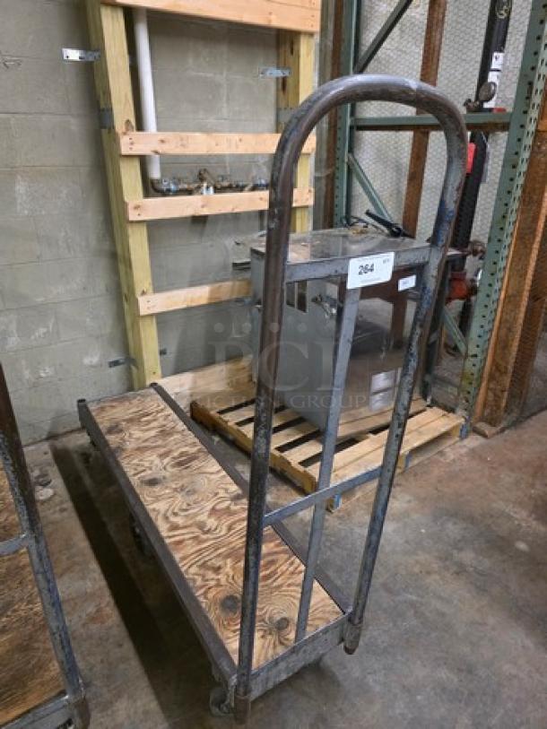 Metal stock cart with wooden platform, sturdy construction, four wheels, moderate wear. Label reads "264."