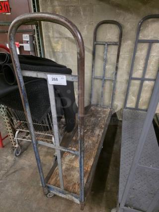 Metal stock cart with two upright handles and wooden base, showing signs of wear. Label 268 attached to handle.