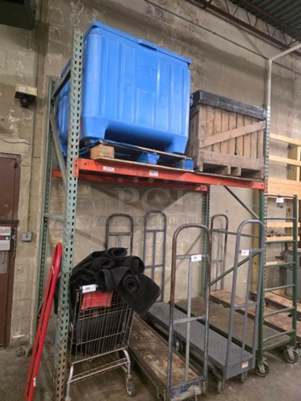 Heavy-duty metal pallet rack in warehouse setting, two-level, used condition, rust-orange beams, green vertical supports.