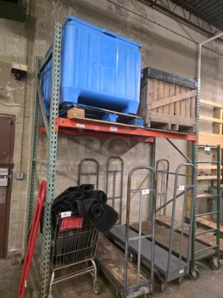 Heavy-duty metal pallet rack in warehouse setting, two-level, used condition, rust-orange beams, green vertical supports.