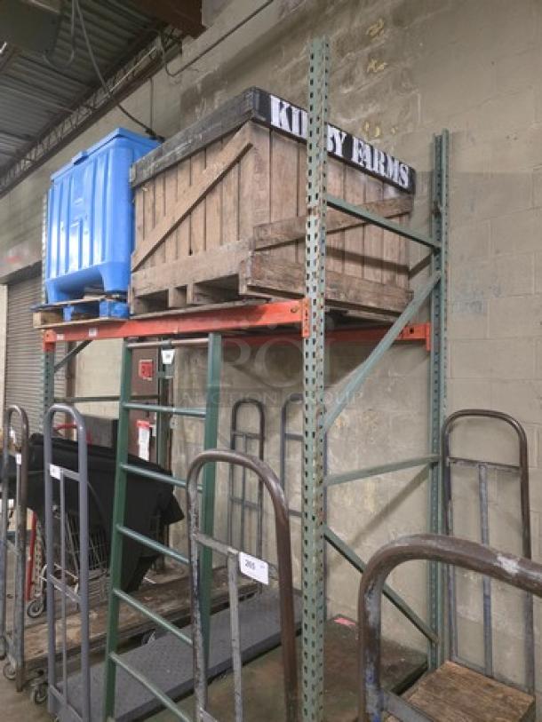 Industrial metal pallet rack, two-tier, green and orange, with visible support beams. Contents on rack not included.