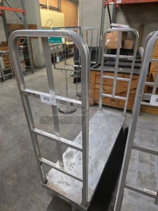 Aluminum mobile cart with dual vertical handlebars, sturdy design, and wheels. Good condition with auction tag 272.