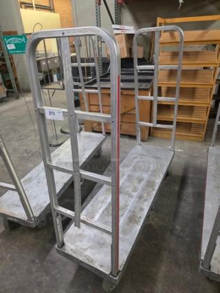 Aluminum mobile cart with dual open shelves, sturdy frame, wheels for mobility. Slight wear, auction lot number 273.