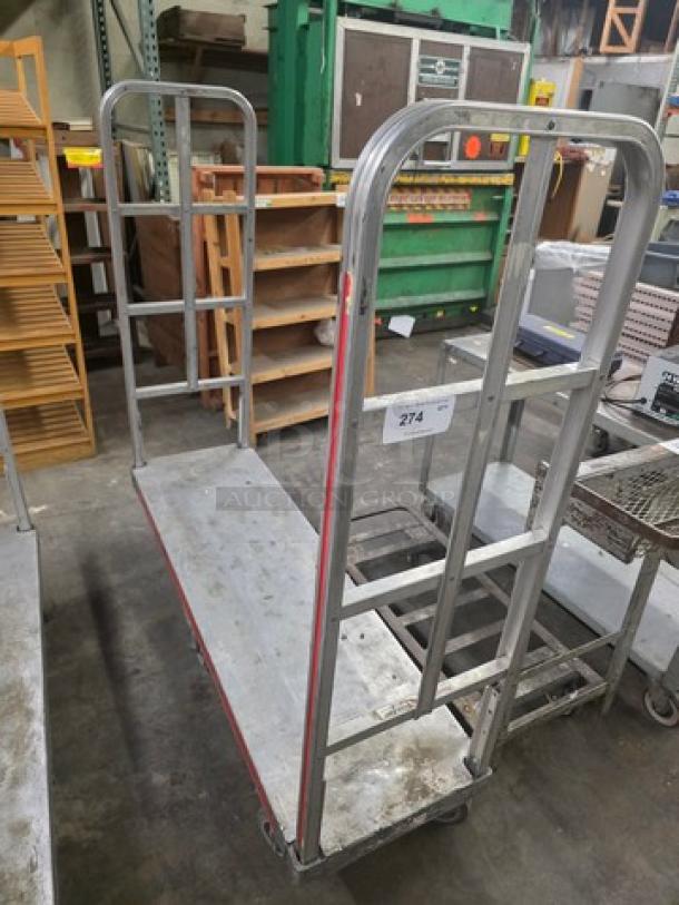 Aluminum mobile cart with vertical bars, used condition, label marked "274," sturdy construction, gray finish.