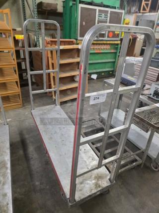 Aluminum mobile cart with vertical bars, used condition, label marked "274," sturdy construction, gray finish.