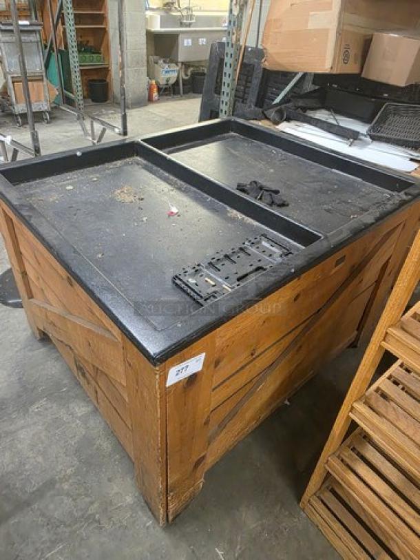 Wooden display bin with a black top, sturdy construction. Visible wear, ideal for retail use. Tag shows item number 277.