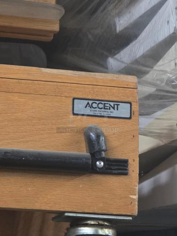 Wooden bench with "Accent by Orr Furniture, Inc." label, sleek metal support, and caster wheel, in good condition.
