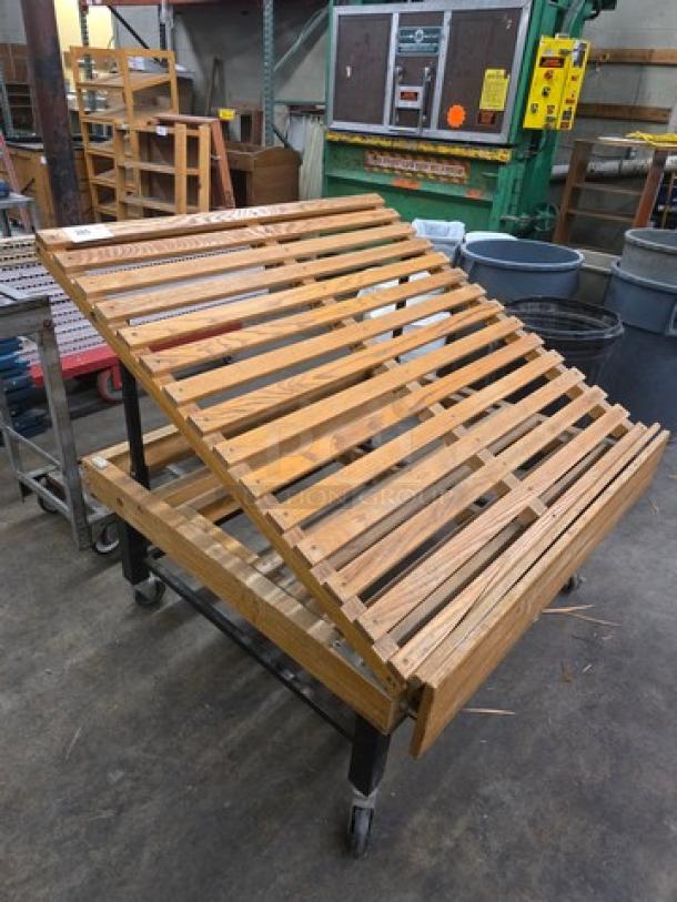 Wooden produce display stand on wheels, adjustable slatted shelves, good condition, sturdy metal frame, ideal for retail use.