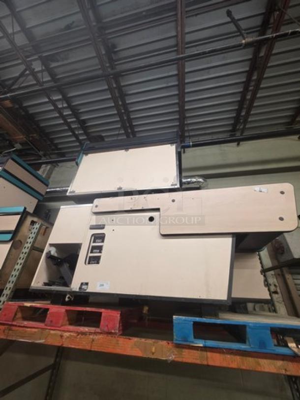 Supermarket checkout counter on pallets, beige finish, unknown condition, with buttons and display panel, labeled "3XBID."