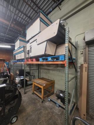 Pallet rack with metal beams in warehouse. Contents on rack not included. Good condition.