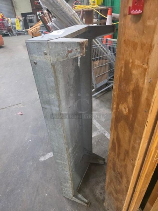 Durable metal dunnage rack, rectangular shape, showing signs of wear. Ideal for warehouse storage.