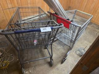 Lot of two shopping carts in used condition; contents not included. One cart has a label "295" on its handle.