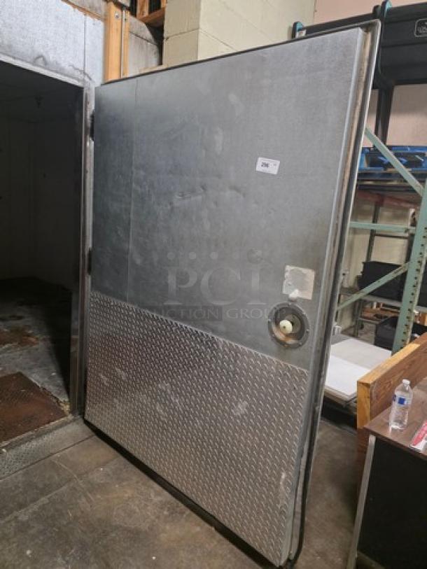 Walk-in door with metal finish, diamond plate lower panel, and mounted hardware. Includes handle and hinges. Good condition.